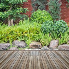 a garden with a rockery and decking