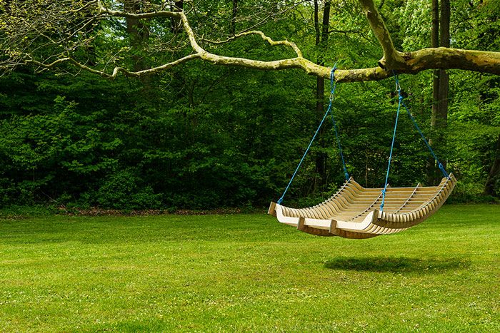 a garden with a hammock hanging from a tree
